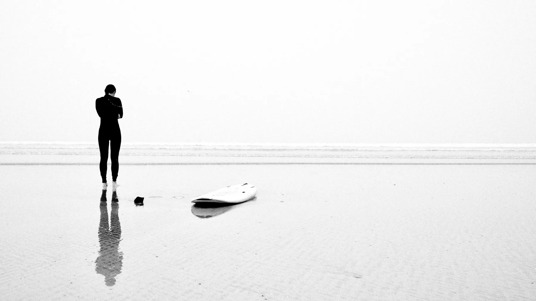 A solitary figure in a reflective landscape